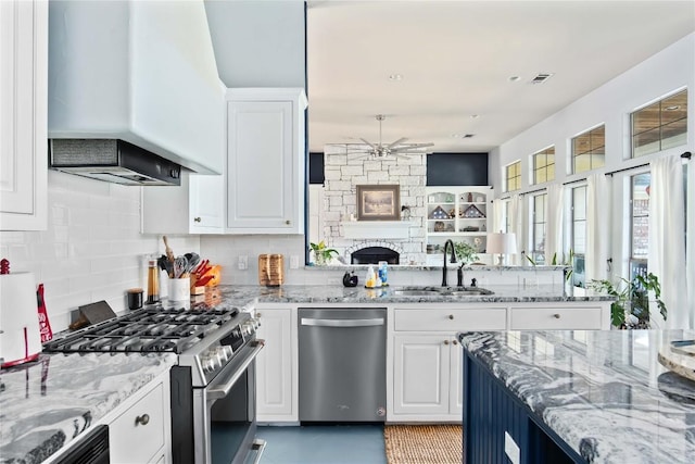 kitchen featuring white cabinetry, sink, stainless steel appliances, and custom range hood