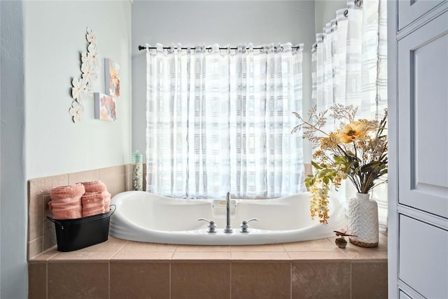 bathroom with a relaxing tiled tub