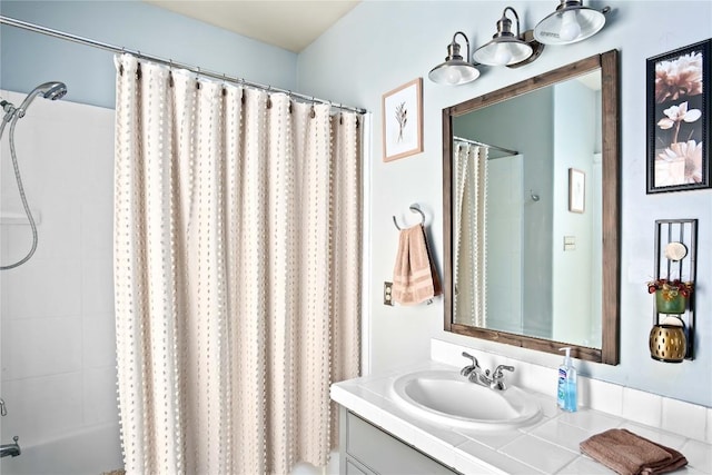 bathroom with shower / tub combo and vanity