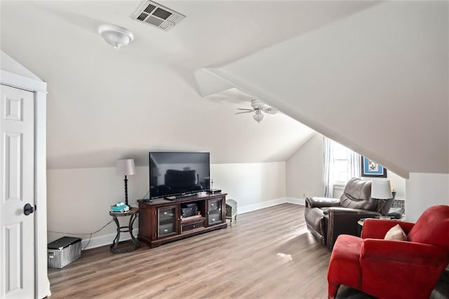 living room with ceiling fan, wood-type flooring, and lofted ceiling