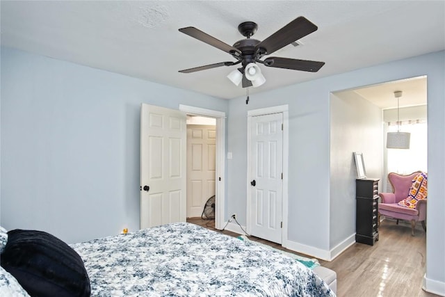 bedroom featuring ceiling fan and light wood-type flooring