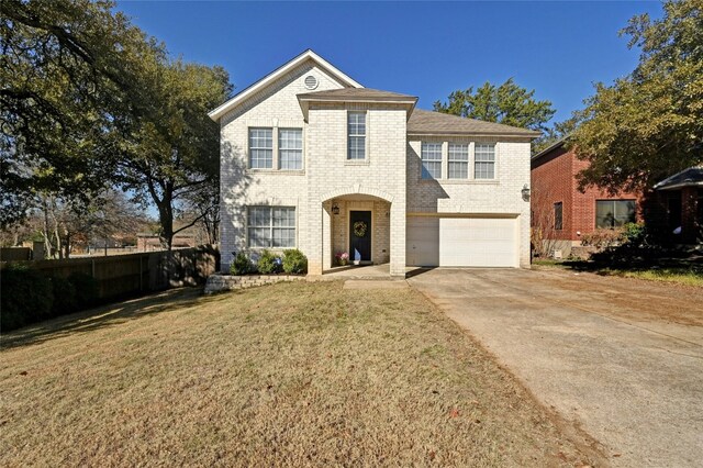 view of front of house featuring a garage and a front lawn