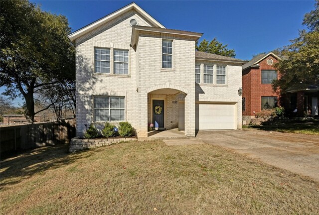 front facade featuring a garage and a front lawn