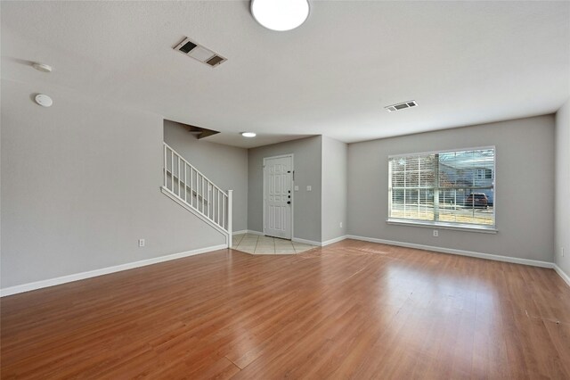 unfurnished living room with light hardwood / wood-style flooring