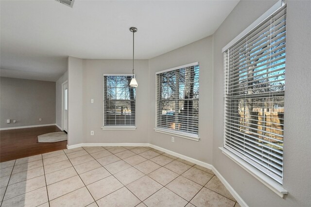 unfurnished dining area featuring light tile patterned floors