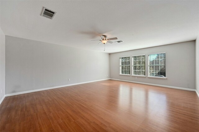 unfurnished room with ceiling fan and light wood-type flooring