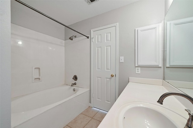 bathroom featuring vanity, tile patterned floors, and washtub / shower combination