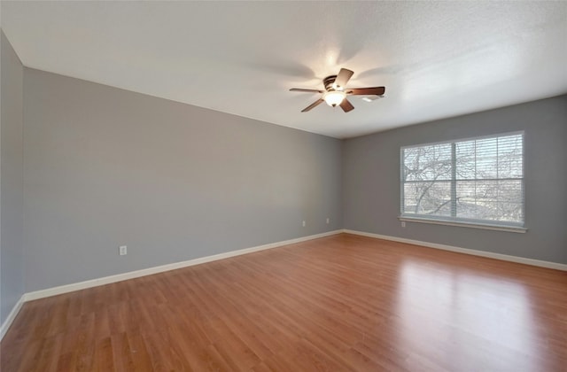 spare room featuring hardwood / wood-style flooring and ceiling fan