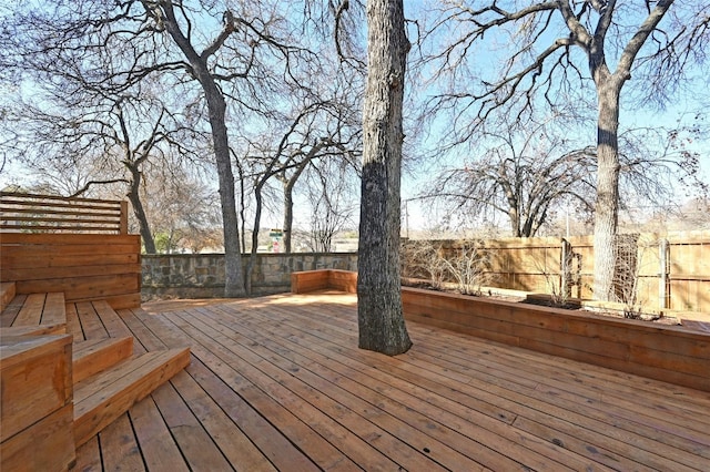 wooden terrace featuring a fenced backyard