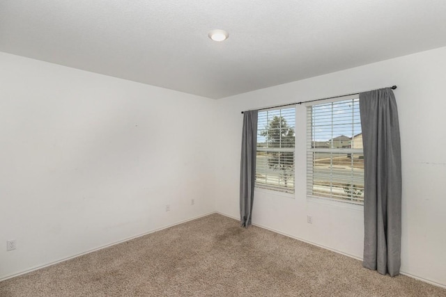 empty room featuring light colored carpet