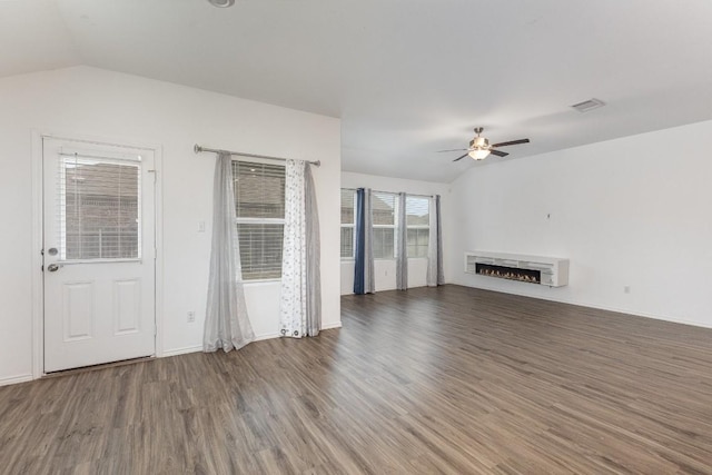 unfurnished living room featuring lofted ceiling, dark hardwood / wood-style flooring, and ceiling fan