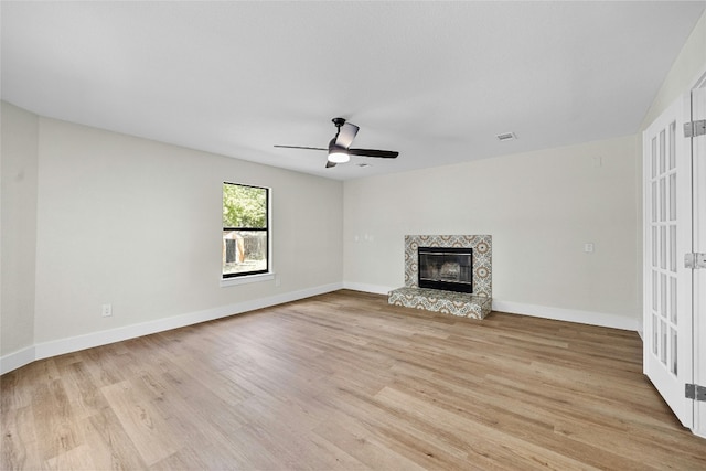 unfurnished living room featuring ceiling fan and light hardwood / wood-style flooring