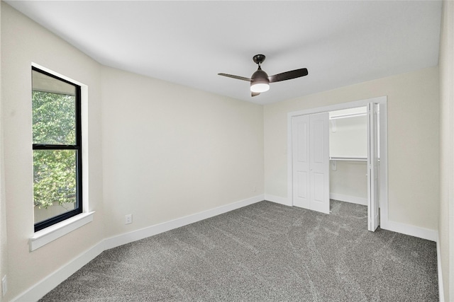 unfurnished bedroom with carpet, ceiling fan, and a closet