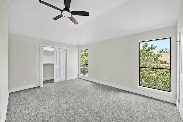 unfurnished bedroom featuring lofted ceiling, carpet floors, and ceiling fan