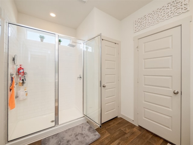 bathroom featuring hardwood / wood-style floors and an enclosed shower