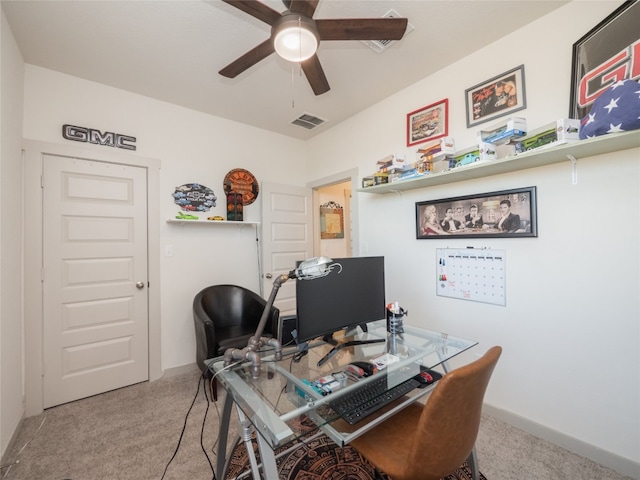 carpeted office space with ceiling fan