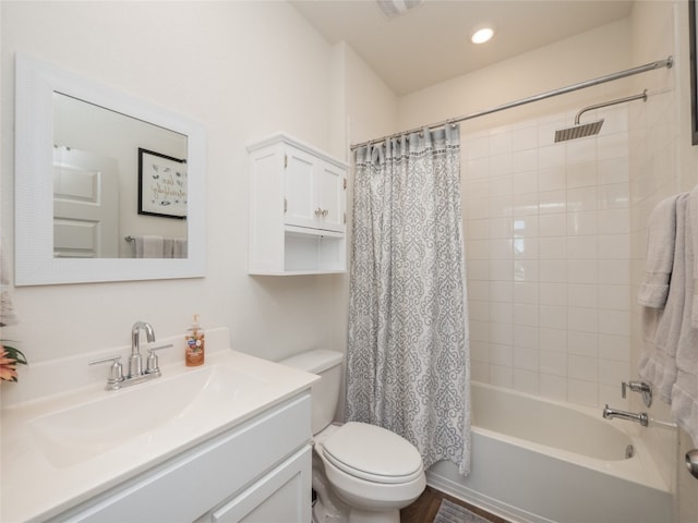 full bathroom with vanity, shower / tub combo, and toilet