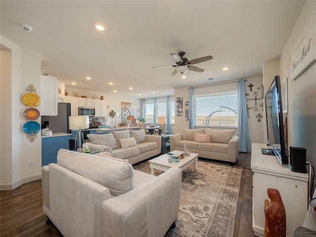 living room with ceiling fan and dark hardwood / wood-style flooring