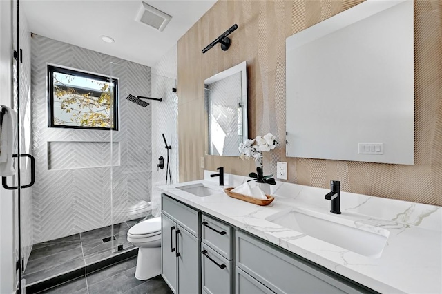 bathroom featuring vanity, walk in shower, and toilet