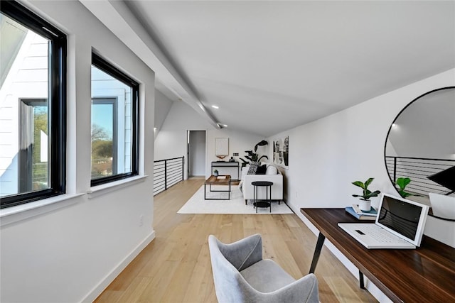 office space with lofted ceiling, a wealth of natural light, and light wood-type flooring