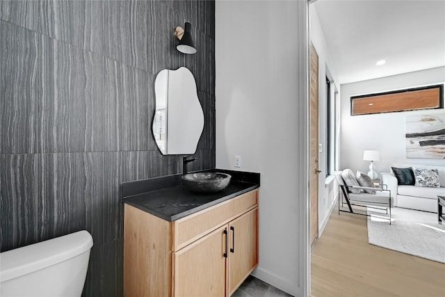 bathroom featuring hardwood / wood-style flooring, vanity, and toilet