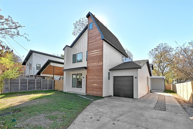 rear view of house with a yard and a garage