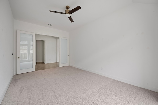 spare room with light colored carpet and ceiling fan