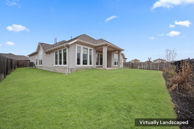 rear view of property featuring a yard