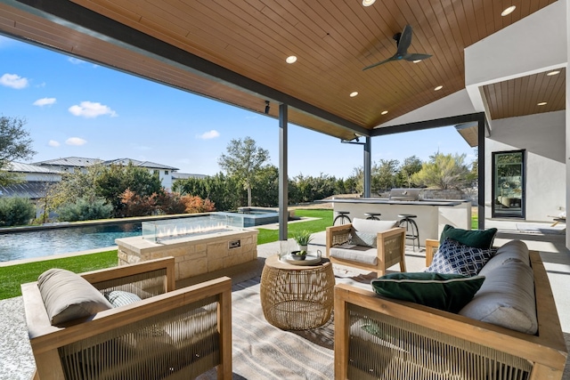 view of patio featuring an outdoor hangout area, a pool with hot tub, ceiling fan, and a bar