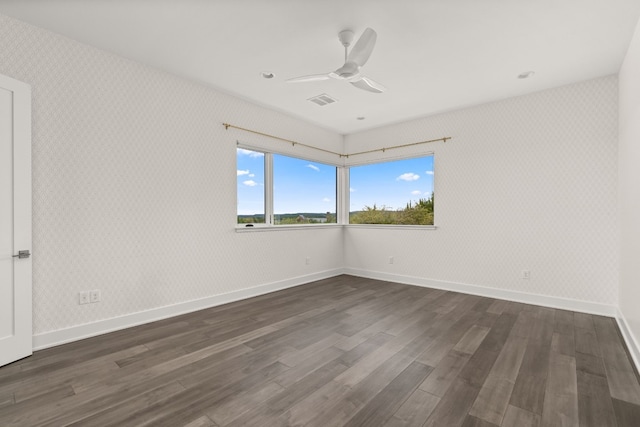 spare room with dark hardwood / wood-style floors and ceiling fan