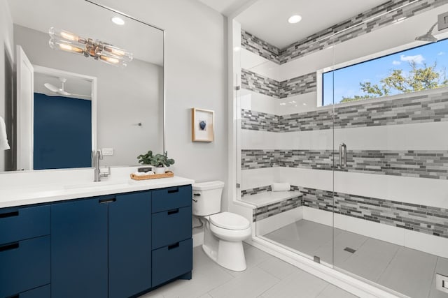 bathroom with vanity, toilet, tile patterned floors, and walk in shower