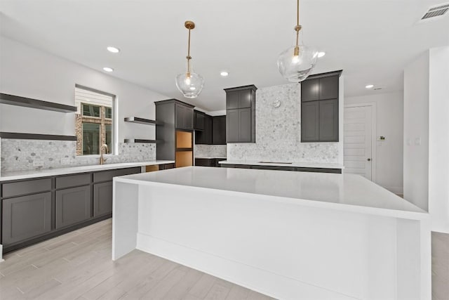 kitchen featuring hanging light fixtures, tasteful backsplash, and a kitchen island