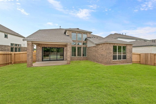 back of property featuring a yard and a patio