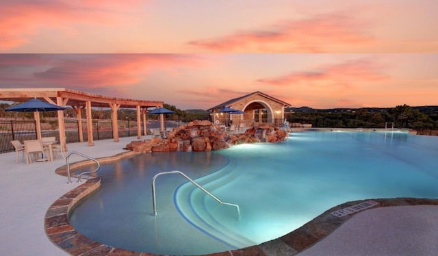 pool at dusk with a pergola