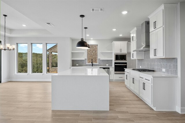 kitchen with light countertops, open shelves, stainless steel appliances, visible vents, and wall chimney exhaust hood