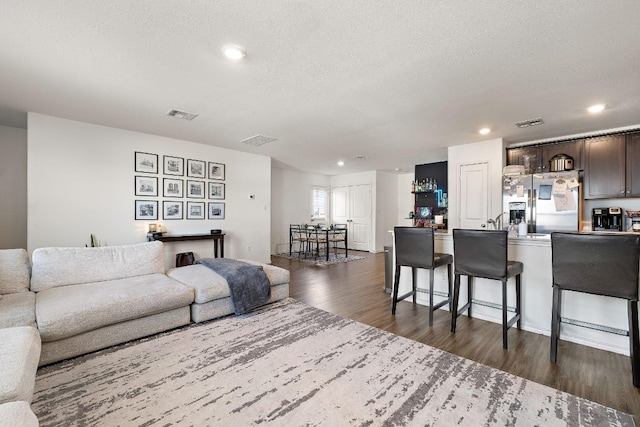 13413 Mussel Run, Elgin, TX 78621 - living room with dark wood-type flooring, recessed lighting, and a textured ceiling