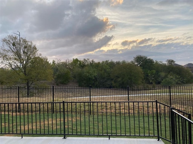 view of gate with a yard