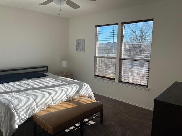 bedroom with dark carpet and ceiling fan