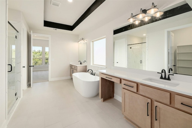 bathroom with a freestanding tub, a sink, and a marble finish shower