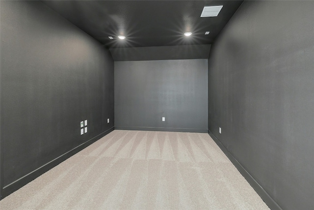 carpeted empty room featuring baseboards, vaulted ceiling, and recessed lighting