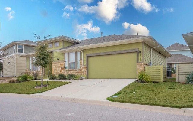 1905 Standing Tall Dr Unit 40, Leander, TX 78641 - view of front of property with stone siding, a garage, a front lawn, and concrete driveway