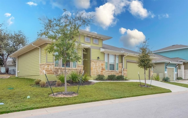 1905 Standing Tall Dr Unit 40, Leander, TX 78641 - view of front of house featuring an attached garage, stone siding, concrete driveway, and a front lawn