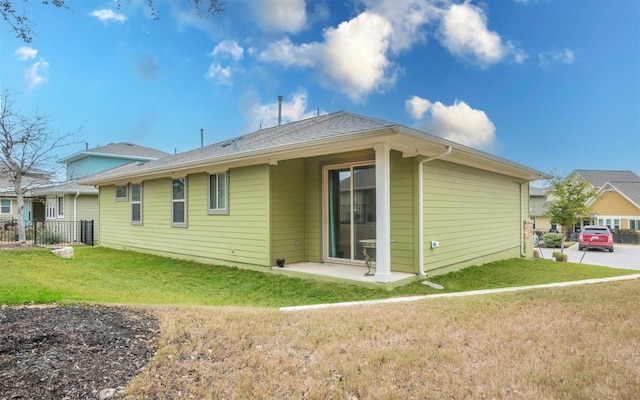 rear view of property with a lawn