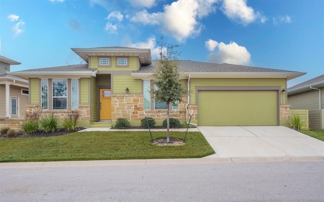 prairie-style home with a garage and a front lawn