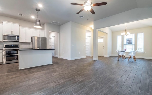 kitchen featuring white cabinetry, tasteful backsplash, decorative light fixtures, appliances with stainless steel finishes, and a kitchen island