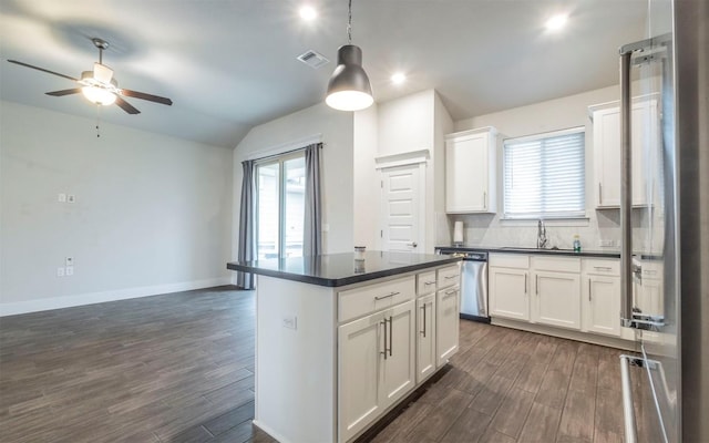 1905 Standing Tall Dr Unit 40, Leander, TX 78641 - kitchen featuring stainless steel dishwasher, dark countertops, dark wood-style floors, lofted ceiling, and recessed lighting