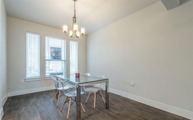 dining space featuring dark hardwood / wood-style flooring, plenty of natural light, and a chandelier