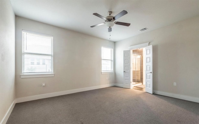 unfurnished bedroom featuring ceiling fan, ensuite bathroom, and carpet flooring