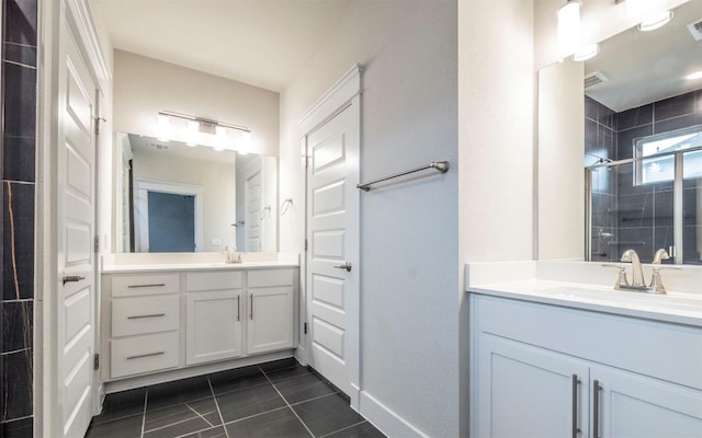 bathroom with walk in shower, vanity, and tile patterned flooring