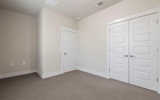 unfurnished bedroom with carpet floors and a closet